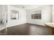Cozy living room with dark wood floors and ample natural light from the large window at 3708 S 104Th Ln, Tolleson, AZ 85353