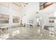 Bright and open living room with soaring ceilings, elegant marble floors, and large windows at 3708 S 104Th Ln, Tolleson, AZ 85353