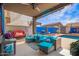 Cozy covered patio with comfortable seating, string lights and a view of the pool at 3708 S 104Th Ln, Tolleson, AZ 85353