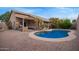 Spacious backyard showcasing a refreshing pool, covered patio, and lush greenery at 3922 N 125Th Dr, Avondale, AZ 85392