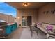 Cozy covered patio with comfortable seating, grill, and access to the backyard at 3922 N 125Th Dr, Avondale, AZ 85392
