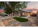A beautifully landscaped home featuring a green lawn, desert landscaping, and a two-car garage at 3922 N 125Th Dr, Avondale, AZ 85392