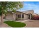 Beautiful home featuring manicured lawn, desert landscaping, and a charming front facade at 3922 N 125Th Dr, Avondale, AZ 85392
