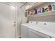 Laundry room featuring washer and dryer, shelves, and a door at 3922 N 125Th Dr, Avondale, AZ 85392