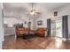 Spacious living room featuring hardwood floors, dual reclining sofas, and backyard access at 3922 N 125Th Dr, Avondale, AZ 85392
