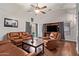 Inviting living room with vaulted ceilings, wood floors, and leather furniture at 3922 N 125Th Dr, Avondale, AZ 85392