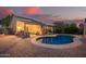 Beautiful backyard showcasing a pool, covered patio, and desert landscaping at 3922 N 125Th Dr, Avondale, AZ 85392
