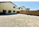 Flat backyard with rock landscaping and block fence at 42418 W Sunland Dr, Maricopa, AZ 85138