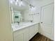 Bathroom with double sink vanity, large mirror, and modern light fixture at 42418 W Sunland Dr, Maricopa, AZ 85138