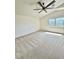 Spacious bedroom with neutral carpet, vaulted ceiling and large window allowing plenty of natural light at 42418 W Sunland Dr, Maricopa, AZ 85138