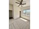 Bedroom featuring neutral carpet, ceiling fan, window and closet with sliding doors at 42418 W Sunland Dr, Maricopa, AZ 85138
