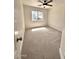 Neutral bedroom with carpet flooring, a ceiling fan, and a bright window view at 42418 W Sunland Dr, Maricopa, AZ 85138