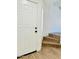 Entryway featuring a white front door, stairs, and wood-style flooring at 42418 W Sunland Dr, Maricopa, AZ 85138