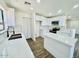 Bright kitchen with white cabinets, stainless steel appliances, and a modern island at 42418 W Sunland Dr, Maricopa, AZ 85138