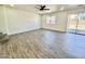 Spacious living room featuring light walls, modern flooring, and a ceiling fan, ideal for comfortable living at 42418 W Sunland Dr, Maricopa, AZ 85138