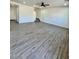 Large living room featuring wood-look floors, stairs to second level, and neutral decor at 42418 W Sunland Dr, Maricopa, AZ 85138