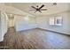 Bright loft space with wood-look flooring, offering a flexible area for relaxation and recreation at 42418 W Sunland Dr, Maricopa, AZ 85138