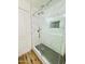 Shower with glass door, modern fixtures, tile surround, and storage niche at 42418 W Sunland Dr, Maricopa, AZ 85138