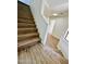 Elegant staircase with wood treads and white risers, enhancing the home's architectural charm at 42418 W Sunland Dr, Maricopa, AZ 85138