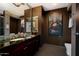 Bathroom with granite countertops, dual sinks, and a unique artistic wall hanging at 4808 N 24Th St # 1424, Phoenix, AZ 85016