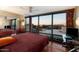 Bedroom with a wall of windows offering panoramic city views and wooden floors at 4808 N 24Th St # 1424, Phoenix, AZ 85016