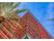 Modern building exterior with glass and metal design, surrounded by palm trees and blue sky at 4808 N 24Th St # 1424, Phoenix, AZ 85016