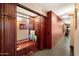 Inviting hallway entrance with custom wood built-ins and a decorative mirror to welcome guests at 4808 N 24Th St # 1424, Phoenix, AZ 85016