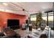 Spacious living area with a large TV, comfortable seating, and expansive windows framing a cityscape at 4808 N 24Th St # 1424, Phoenix, AZ 85016