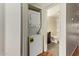Hallway laundry closet and a bathroom with a vanity, toilet, and shower-tub combination at 4901 S Calle Los Cerros Dr # 219, Tempe, AZ 85282