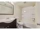 A well-lit bathroom featuring a vanity, toilet, and shower-tub combination with a white shower surround at 4901 S Calle Los Cerros Dr # 219, Tempe, AZ 85282