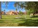 A well-maintained community lawn with picnic tables and shade trees under a blue sky at 4901 S Calle Los Cerros Dr # 219, Tempe, AZ 85282