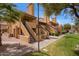 Exterior view of the condo with desert landscaping, terracotta roofing, and private stairways leading to units at 4901 S Calle Los Cerros Dr # 219, Tempe, AZ 85282