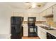Well-lit kitchen with black appliances and white cabinets at 4901 S Calle Los Cerros Dr # 219, Tempe, AZ 85282