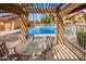 View of the refreshing community pool from under a wooden pergola at 4901 S Calle Los Cerros Dr # 219, Tempe, AZ 85282