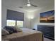 Cozy bedroom featuring a large bed, modern ceiling fan, picture window and an outdoor view at 5100 E Rancho Paloma Dr # 1044, Cave Creek, AZ 85331