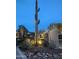 Night shot of the community entrance with desert landscaping and stone accents creates a welcoming first impression at 5100 E Rancho Paloma Dr # 1044, Cave Creek, AZ 85331