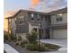 Charming two-story home boasts manicured landscaping and a warm, inviting facade at sunset at 5100 E Rancho Paloma Dr # 1044, Cave Creek, AZ 85331