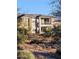 Two story home with a balcony is seen through the trees and desert landscape at 5100 E Rancho Paloma Dr # 1044, Cave Creek, AZ 85331