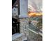 Inviting porch with stone detailing offers a scenic view of the Arizona desert landscape during sunset at 5100 E Rancho Paloma Dr # 1044, Cave Creek, AZ 85331