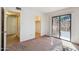This bedroom has carpeted floors and a sliding glass door to the exterior at 5757 W Eugie Ave # 1080, Glendale, AZ 85304