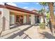 Welcoming clubhouse featuring a tile roof, mature palms, and glass paneled doors at 5757 W Eugie Ave # 1080, Glendale, AZ 85304