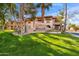 Beautiful condo community entrance with lush landscaping and mature shade trees at 5757 W Eugie Ave # 1080, Glendale, AZ 85304