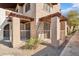 Condo exterior view showcasing a cozy gated patio area and beautiful desert landscaping at 5757 W Eugie Ave # 1080, Glendale, AZ 85304