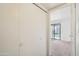 Hallway closet with white doors leads to a carpeted room with sliding glass doors to the exterior at 5757 W Eugie Ave # 1080, Glendale, AZ 85304