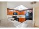 This kitchen features wood cabinets, speckled countertops and black appliances at 5757 W Eugie Ave # 1080, Glendale, AZ 85304
