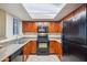 Kitchen with wood cabinets, black appliances, and a skylight for natural lighting at 5757 W Eugie Ave # 1080, Glendale, AZ 85304