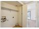The laundry room includes a shelf for storage and an exterior view from the open doorway at 5757 W Eugie Ave # 1080, Glendale, AZ 85304