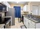 Bright kitchen with white cabinetry, stainless steel appliances, and sleek countertops at 625 S Westwood -- # 121, Mesa, AZ 85210
