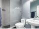 Modern bathroom featuring a glass-enclosed shower, sleek toilet, and contemporary sink, perfect for a clean look at 639 N 110Th Pl, Mesa, AZ 85207