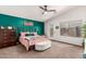 Bright bedroom features a ceiling fan, accent wall, and comfortable decor at 639 N 110Th Pl, Mesa, AZ 85207